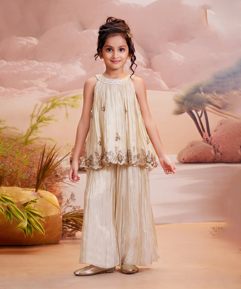 Cream palazzo set for girls with embellished sleeveless top and wide-leg pants, Jaipur wedding style

