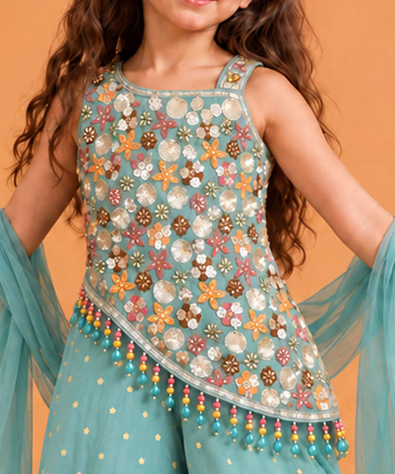 Asymmetrical slanted bottom hemline on the top featuring multi-colored hanging beaded tassels.   