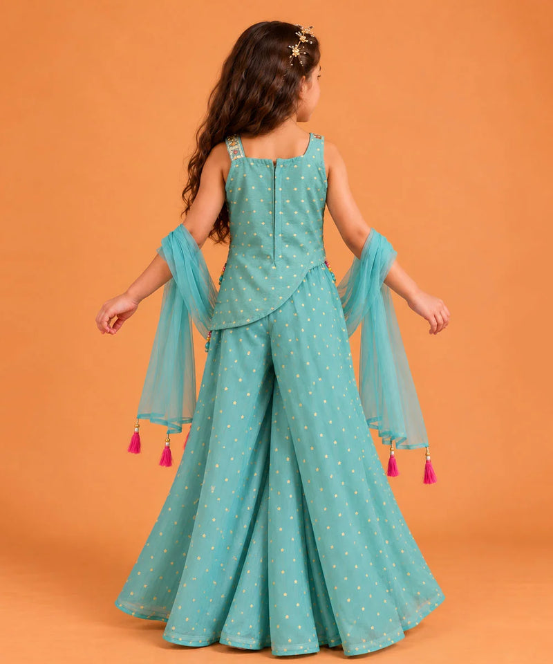 Wide flared sea green sharara pants decorated with tiny golden star print motifs.   