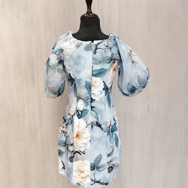 Floral dress on a mannequin against a beige wall