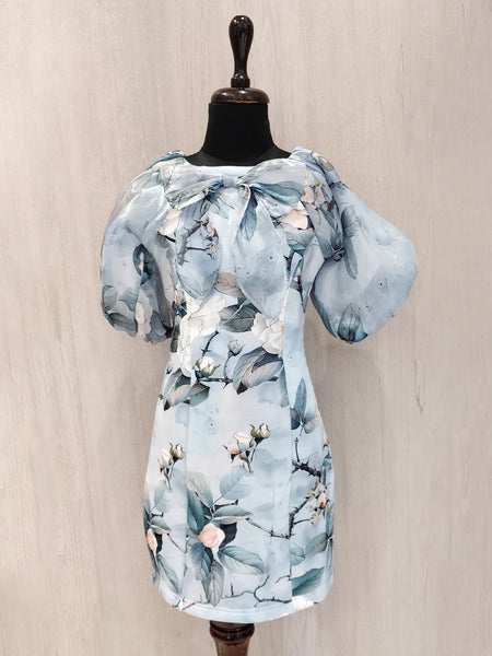 Light blue floral dress on a mannequin against a beige background