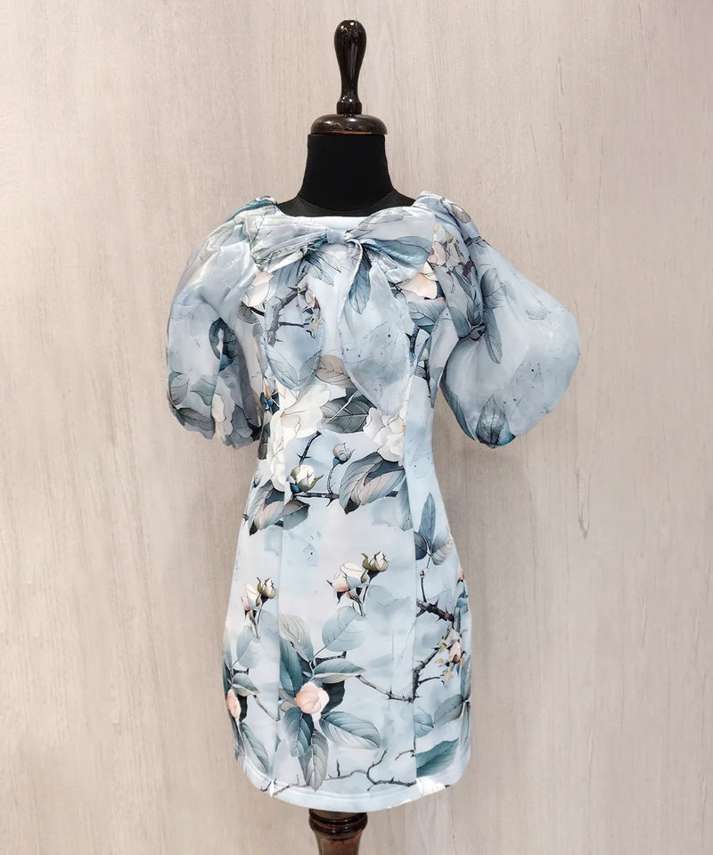 Light blue floral dress on a mannequin against a beige background
