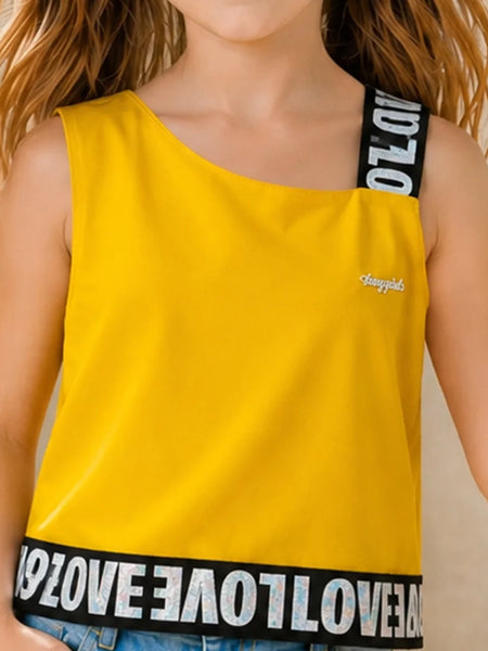 A child wearing a bright yellow one-shoulder tank top with black shoulder straps and a black hemband featuring white 'LOVE' lettering. The top has a small white script logo on the chest.