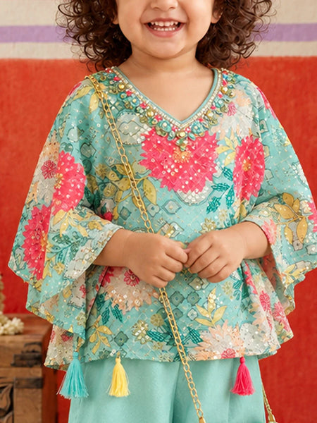 Flared kaftan sleeves with colorful floral motifs.   