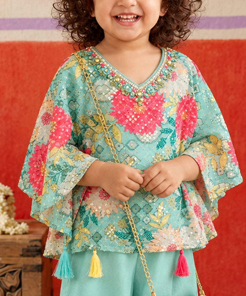 Flared kaftan sleeves with colorful floral motifs.   