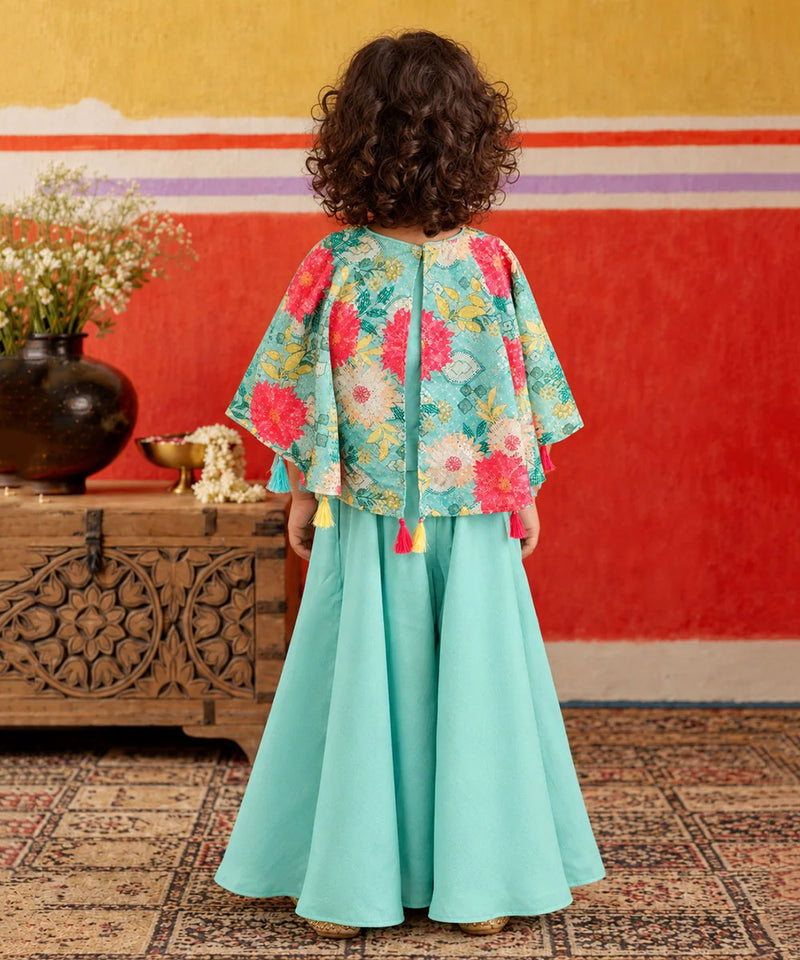 Bright tassel hanging embellishments along the shirt hemline.   