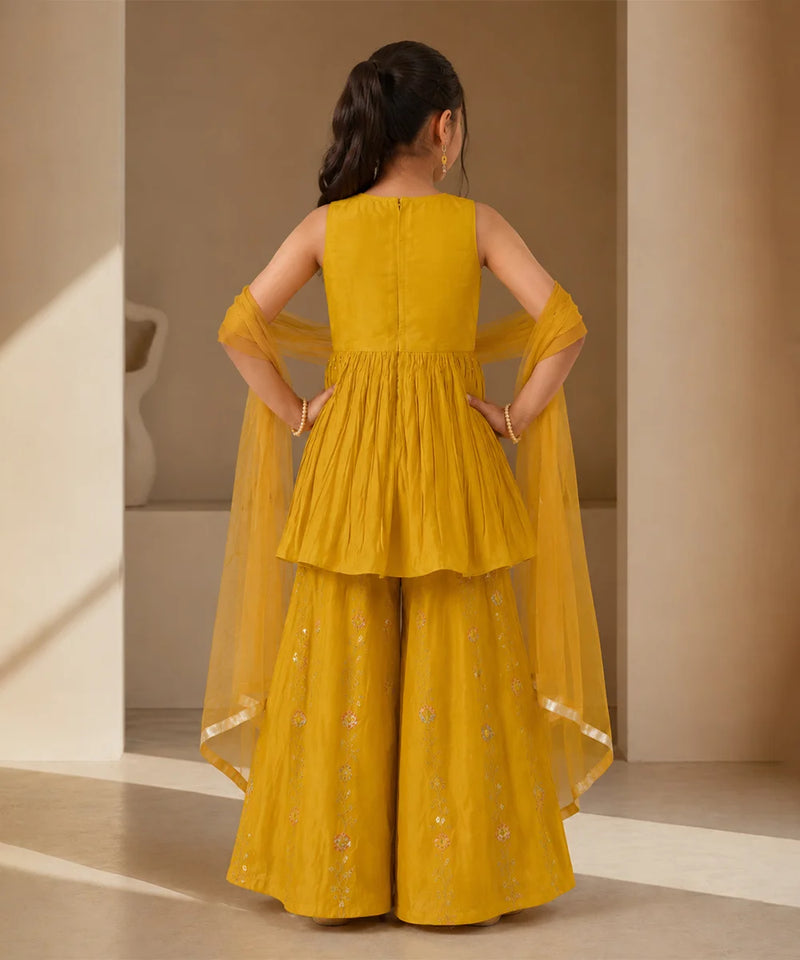 Mustard yellow sleeveless kurta with matching sharara and dupatta.