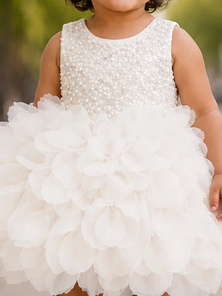 Close-up of baby girls' white frock beaded bodice