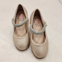 Pair of glittery shoes with rhinestone straps on a light background