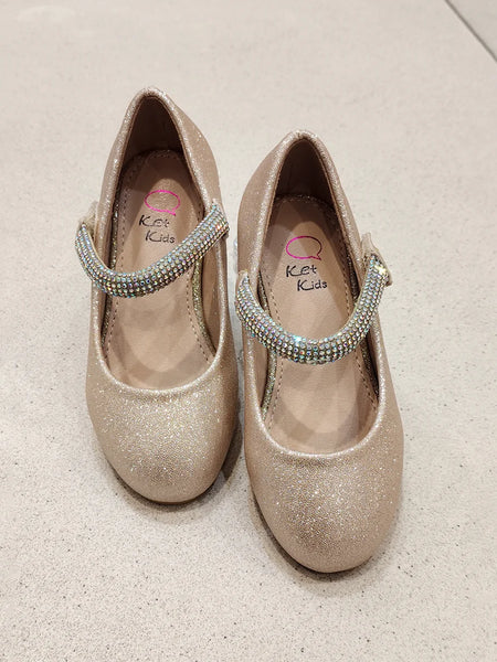 Pair of glittery shoes with rhinestone straps on a light background