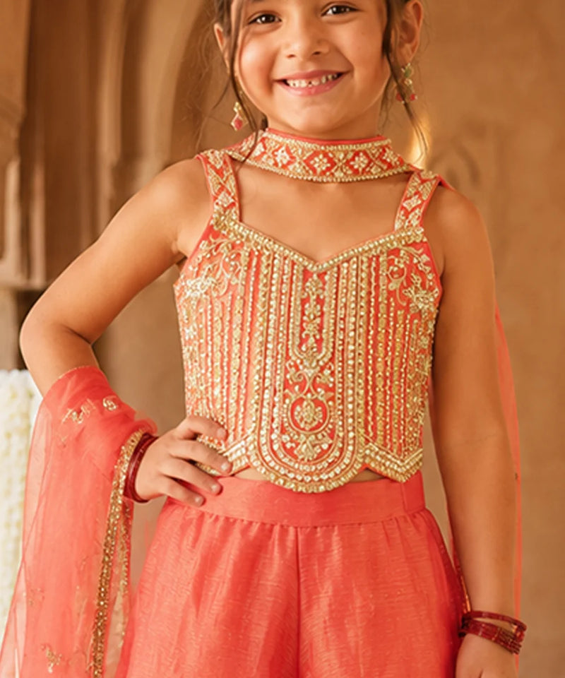 Orange sleeveless top with matching flared sharara.