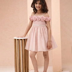 Young girl wearing a pink dress with floral details against a beige background