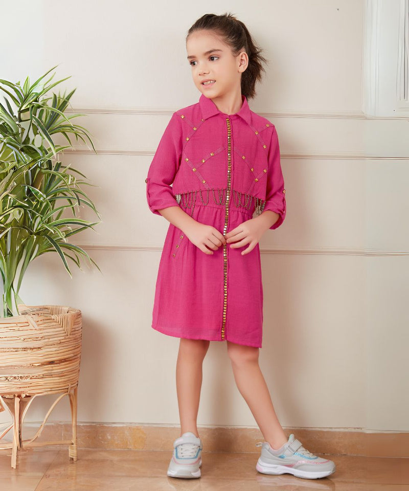  It’s a pink coloured fancy girl dress for a party with an elasticated waist. It features beautiful golden work and chain detailing on the dress.