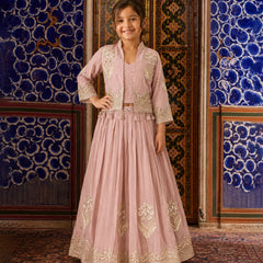 Girl wearing a pink embroidered lehenga with jacket.