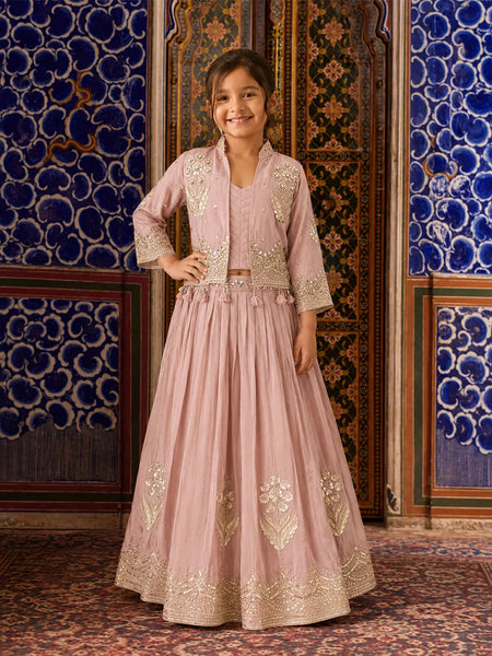 Girl wearing a pink embroidered lehenga with jacket.