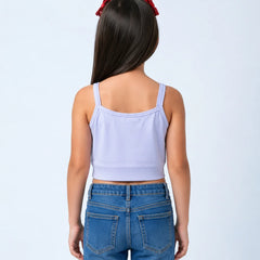 A young girl viewed from behind wearing a light lavender sleeveless crop top and blue jeans, with two red hair bows in her dark hair, against a light blue studio background.