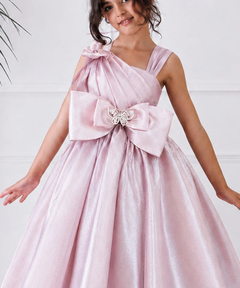 Pink dress with a large bow and butterfly detail on a white background