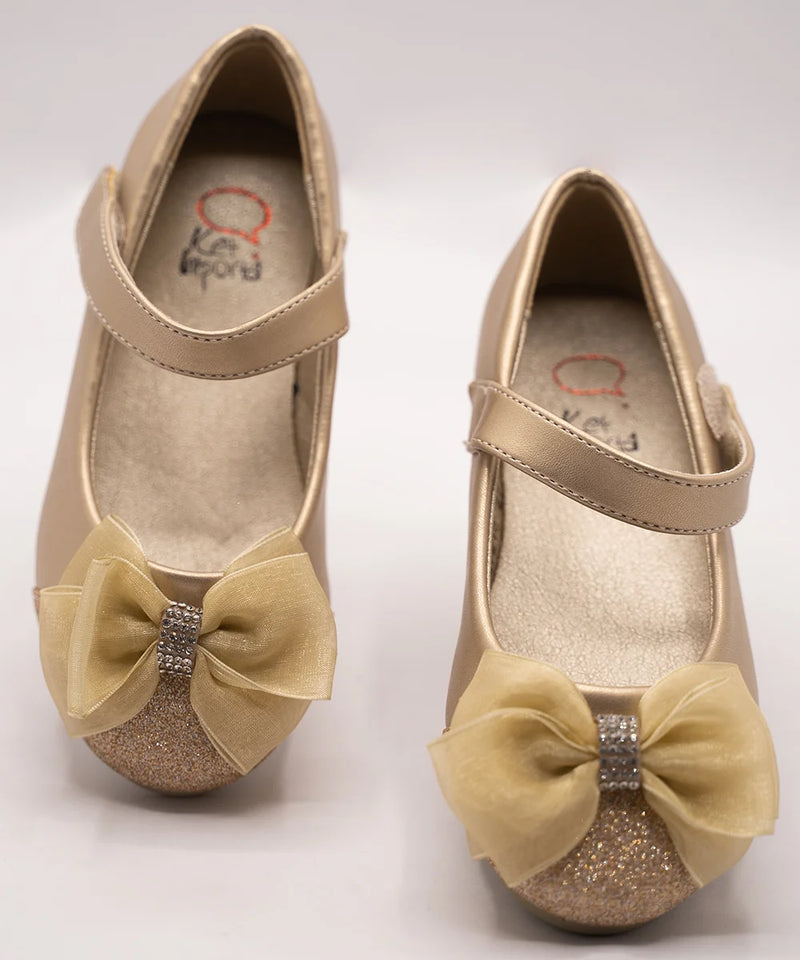 Close-up of girls' gold ballerina shoes with sparkling toe and bow accent, perfect for festive occasions in Jaipur