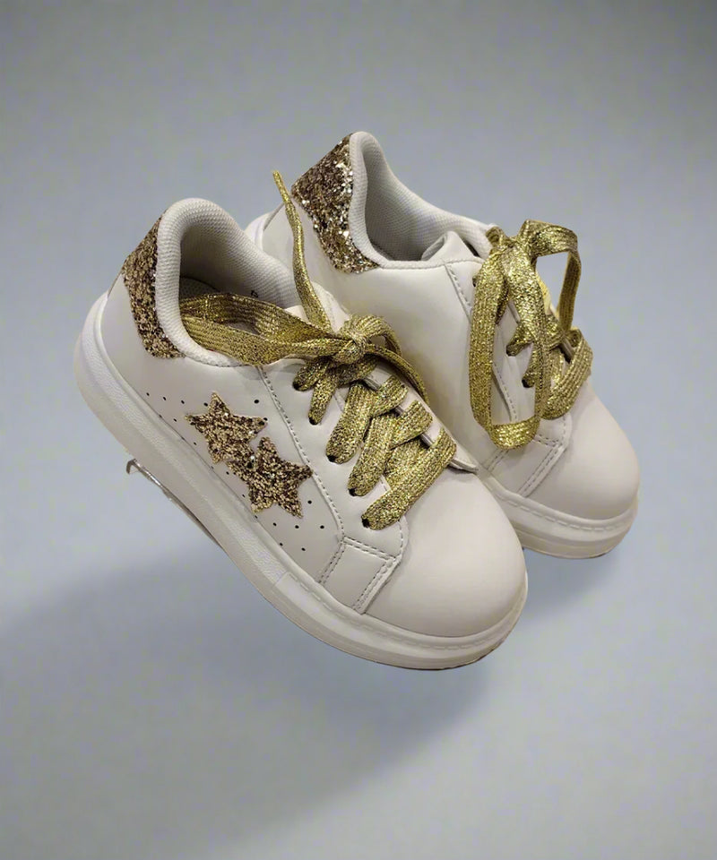 Close-up of trendy girls' white sneakers with gold glitter accents and cushioned sole, Jaipur
