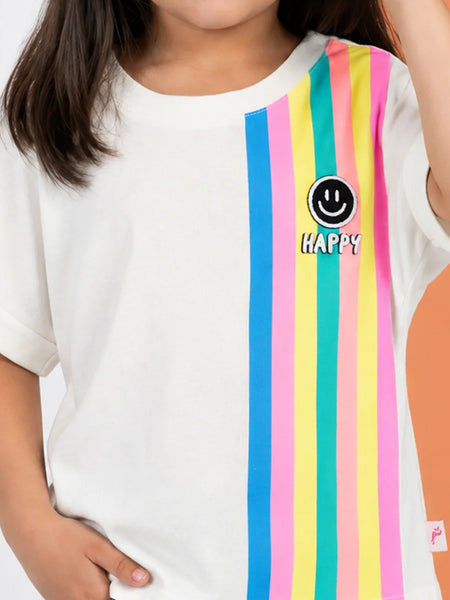 A child wearing a white short-sleeve t-shirt with vertical pastel stripes in blue, pink, yellow, and green on the right side, featuring a black smiley face logo and the word 'HAPPY' in white text.