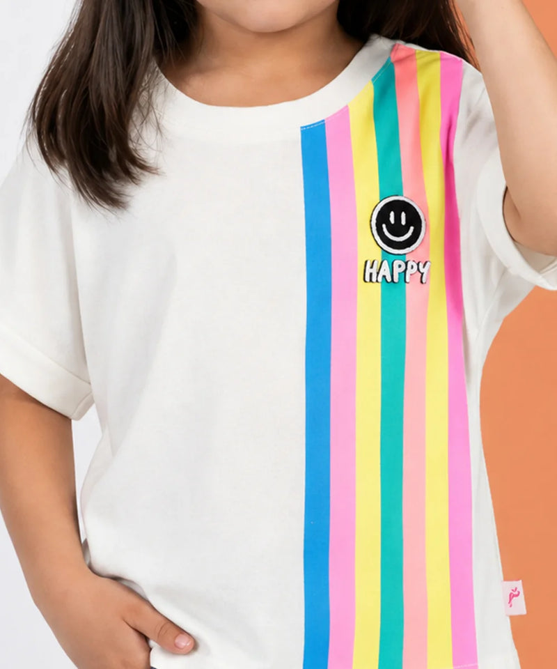 A child wearing a white short-sleeve t-shirt with vertical pastel stripes in blue, pink, yellow, and green on the right side, featuring a black smiley face logo and the word 'HAPPY' in white text.