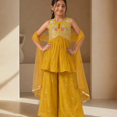 Girl wearing a mustard yellow embroidered sharara set with dupatta.