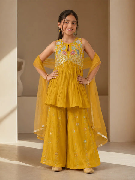 Girl wearing a mustard yellow embroidered sharara set with dupatta.