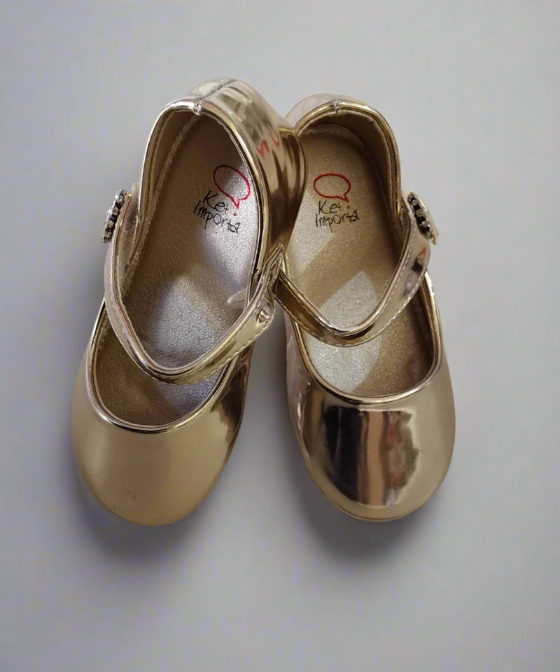 Close-up of girls' metallic gold dress shoes with embellished strap, perfect for festive occasions in Jaipur