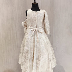 White lace dress on a mannequin against a plain background