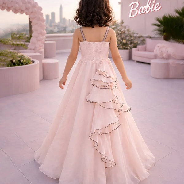 Woman in a pink dress standing on a rooftop with a cityscape and 'Barbie' sign in the background.