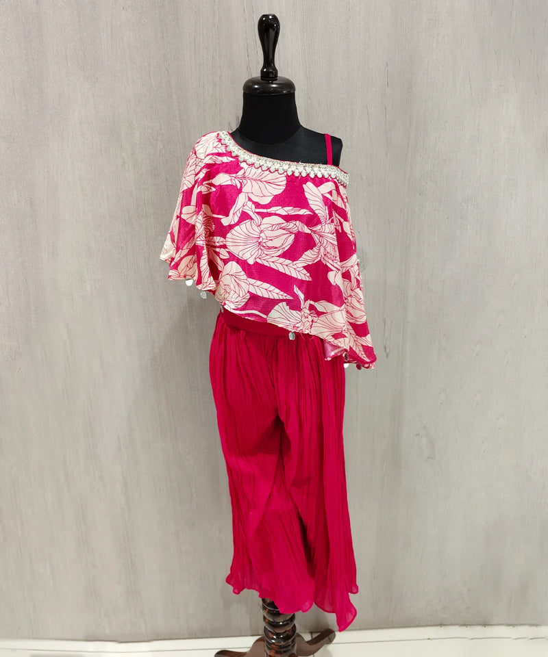 Mannequin wearing a pink floral top and pants against a gray background