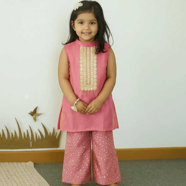Young girl wearing a pink traditional outfit with a white background