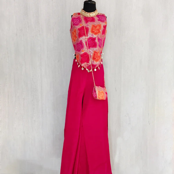 Mannequin wearing a vibrant outfit with a pink top and pants against a white background