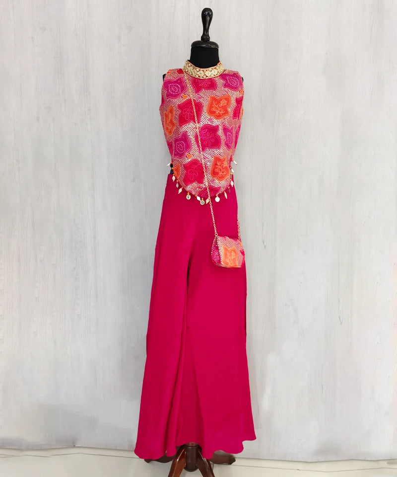 Mannequin wearing a vibrant outfit with a pink top and pants against a white background