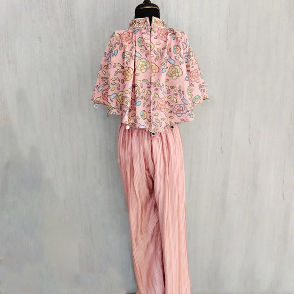 Mannequin wearing a pink floral blouse and matching pants against a light gray background