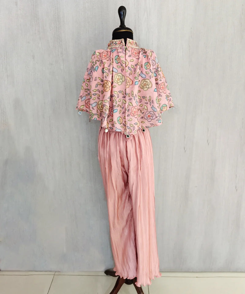 Mannequin wearing a pink floral blouse and matching pants against a light gray background