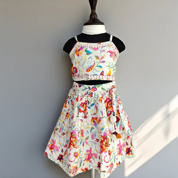 Colorful floral dress on a mannequin against a plain background