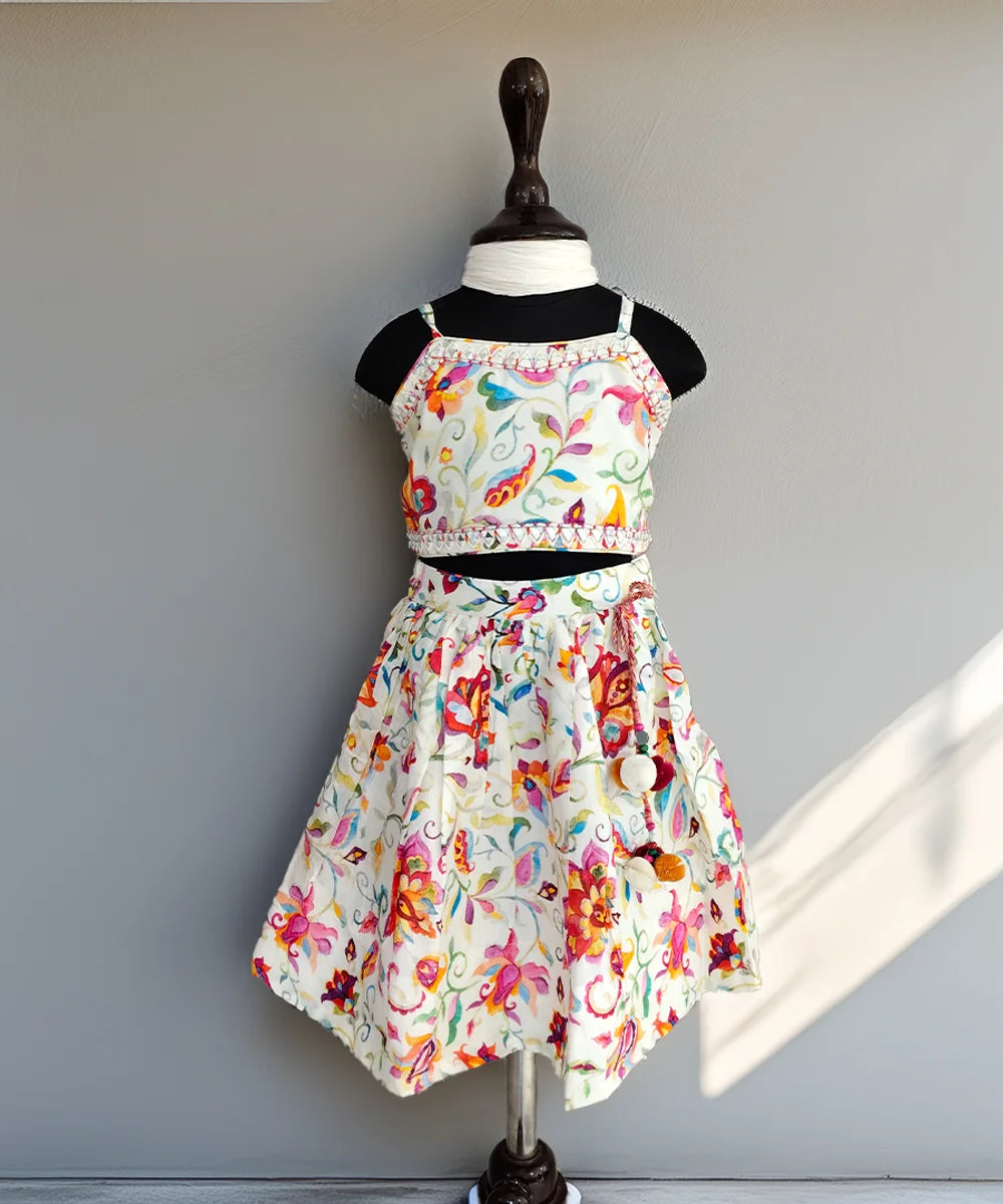 Colorful floral dress on a mannequin against a plain background