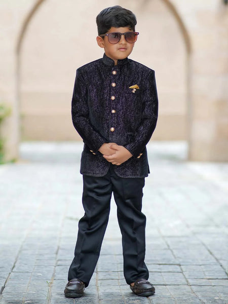 It consists of a black Colored full-sleeved Jodhpuri paired with matching black pants enhanced by shimmer lines and an elegant broach. 