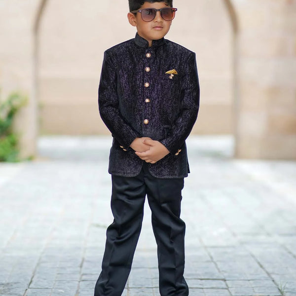 It consists of a black Colored full-sleeved Jodhpuri paired with matching black pants enhanced by shimmer lines and an elegant broach. 