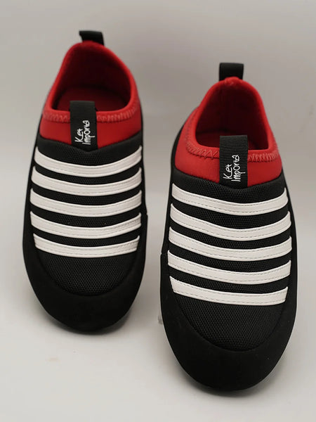 Kids' black slip-on sneakers with bold white stripes and red collar, Jaipur