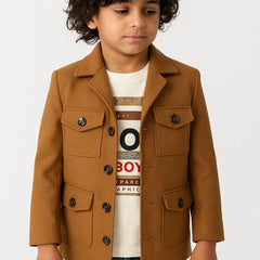 Child wearing a brown jacket over a graphic t-shirt on a white background