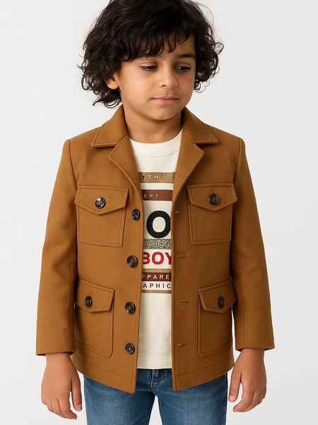 Child wearing a brown jacket over a graphic t-shirt on a white background