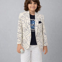 Child wearing a patterned blazer and white shorts on a plain background