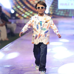 Child model walking on a fashion show runway wearing a colourful party wear printed blazer in Jaipur