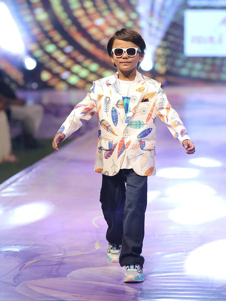 Child model walking on a fashion show runway wearing a colourful party wear printed blazer in Jaipur