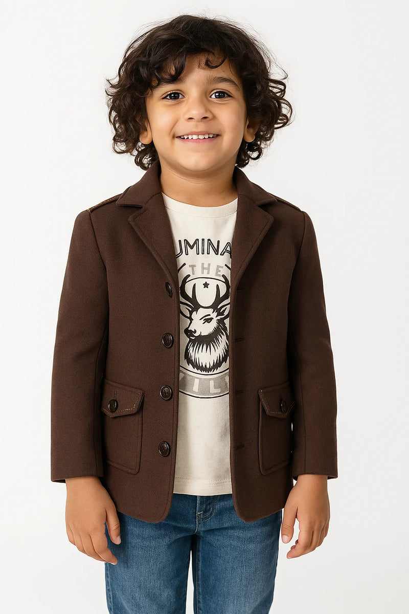 Child wearing a brown blazer over a graphic t-shirt on a white background