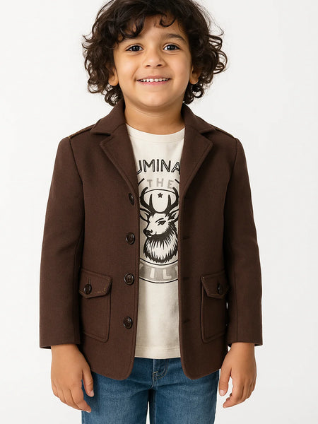 Child wearing a brown blazer over a graphic t-shirt on a white background