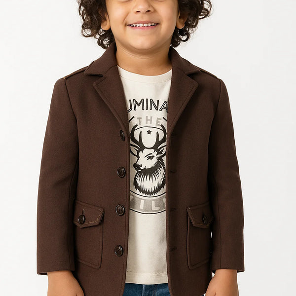 Child wearing a brown blazer over a graphic t-shirt on a white background