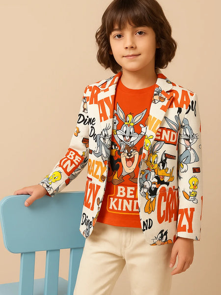 Child wearing a colorful jacket with cartoon characters and text, sitting on a blue chair against a beige background.